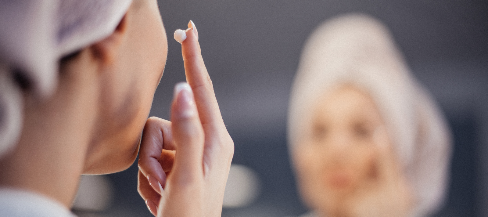 Woman applying face cream