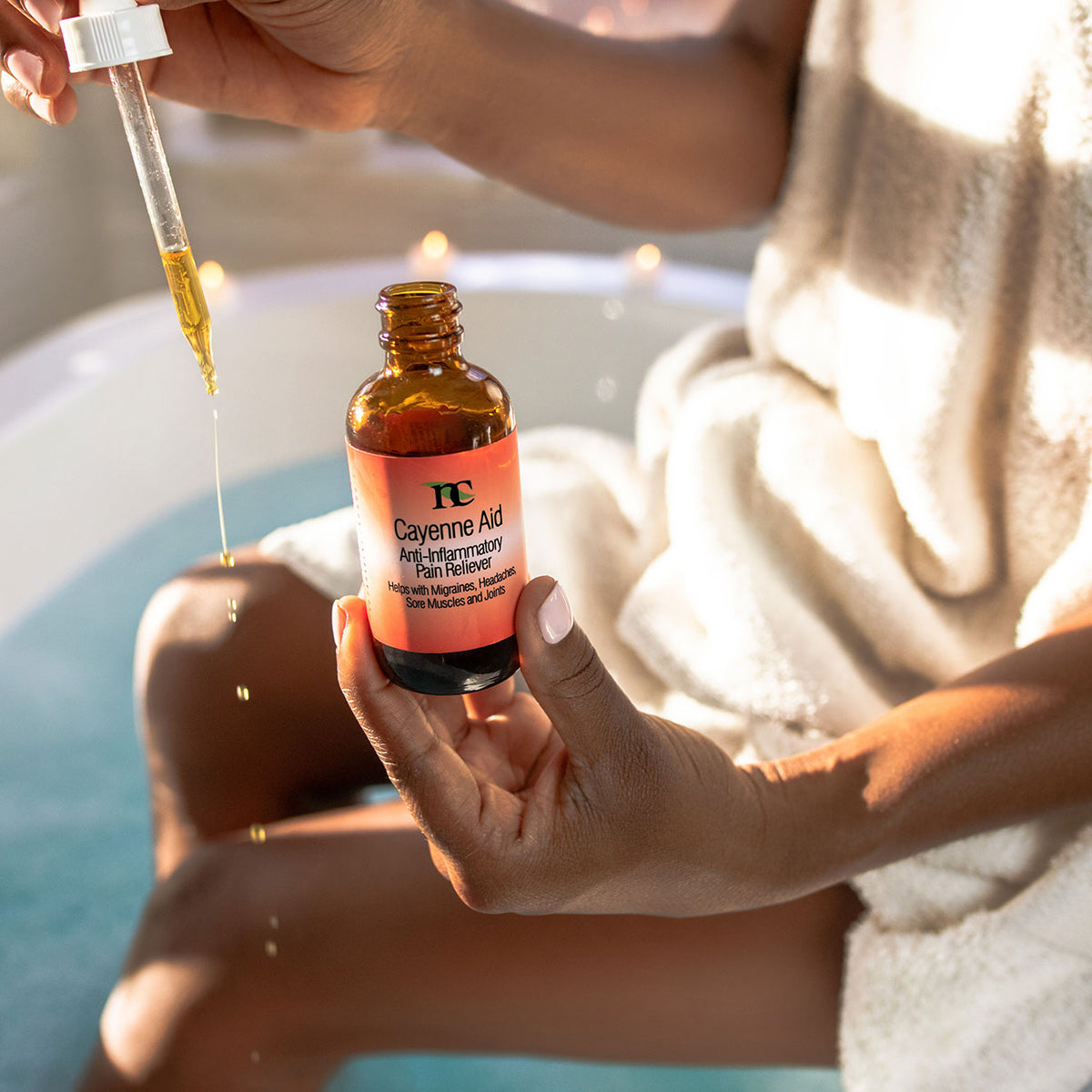 Cayenne Aid model photo showing oil dropping on to skin