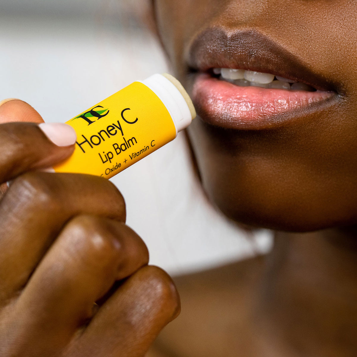 Honey C Lip Balm model photo showing woman using the product